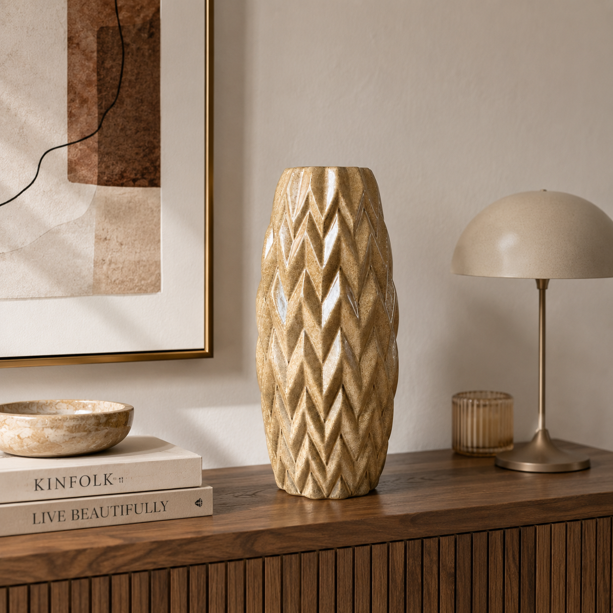 Ceramic vase with geometric pattern on a ceramic surface with books and a lamp.
